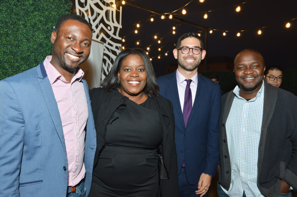 Four young patrons pose at an event.
